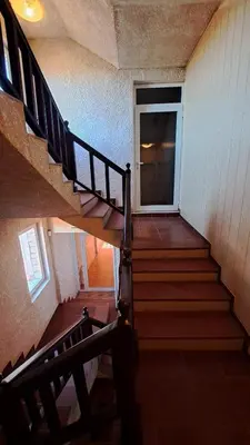 a staircase leading to a door in a house at REAL Guest House in Bansko