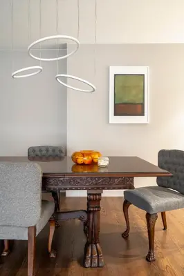 a dining room table with two chairs and a painting at NEW High-End Designer 3BR Central Apt Free Parking in Sofia