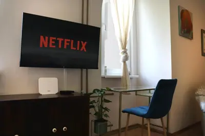 a desk with a tv and a chair in a room at Spacious and Central Vintage - Modern Apartment in Sofia