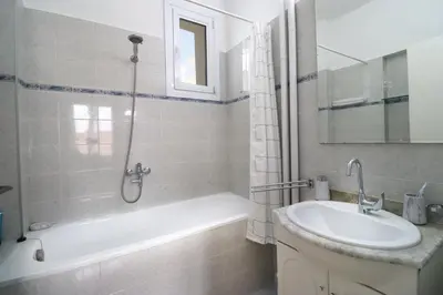 a bathroom with a tub and a sink and a shower at Spacious and Central Vintage - Modern Apartment in Sofia