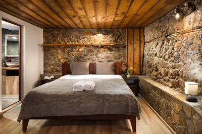 a bedroom with a bed with towels on it at Vila Toplika in Kara Agach