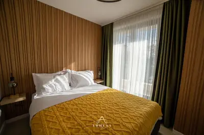 a hotel room with a bed and a window at ARHEYA 3 apart АРХЕЯ 3 апартамент за гости in Karlovo