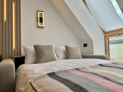 a bedroom with a large bed and a window at City Modern & Classy Apartment for 4 Guests & Parking in Sofia