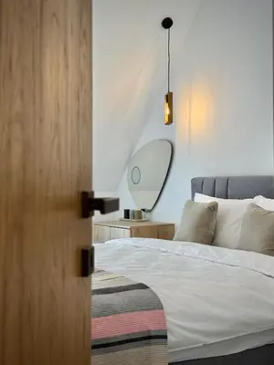 a bedroom with a bed and a mirror on a table at City Modern & Classy Apartment for 4 Guests & Parking in Sofia