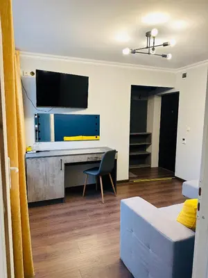 a living room with a desk and a tv at VELI HOUSE VELINGRAD/ ВелиХаус Къща за гости Велинград in Velingrad