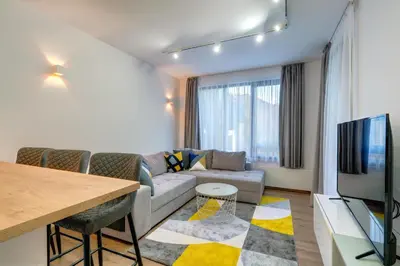 a living room with a couch and a table at N.Joy Holiday Apartment 534 by Oak Residence in Smolyan