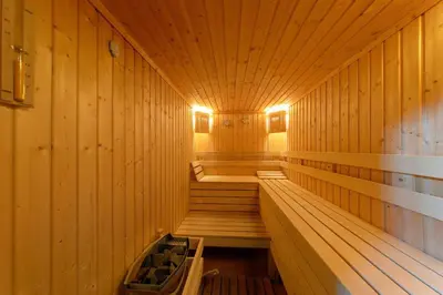 a sauna with wooden walls and wooden stairs in it at N.Joy Holiday Apartment 534 by Oak Residence in Smolyan