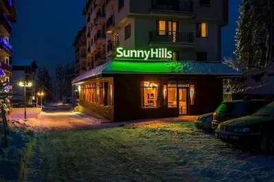 a building with a sign that reads summary kills at N.Joy Holiday Apartment 413 by Sunny Hills in Pamporovo