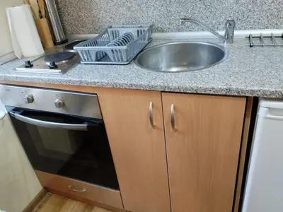 a kitchen counter with a sink and a dishwasher at Predela 1 - Studio 04 near Bansko Ski Lift in Bansko