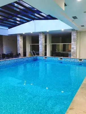 a large swimming pool with blue water in a building at Predela 1 - Studio 04 near Bansko Ski Lift in Bansko