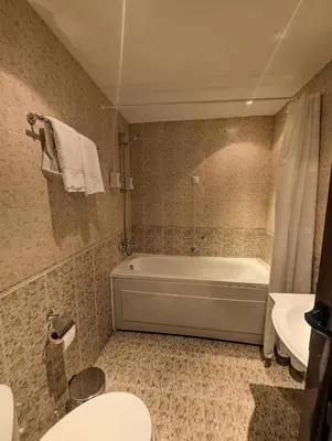 a bathroom with a tub and a toilet and a sink at Great View Apartment near Gondola in Bansko