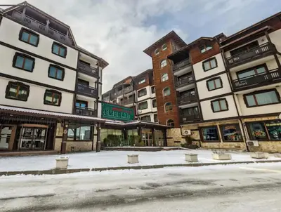 a group of buildings with snow on the ground at Ski view suite Emerald Bansko in Bansko