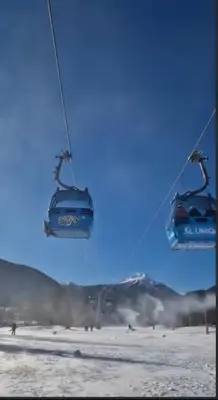 a pair of ski lift chairs in the snow at Ski view suite Emerald Bansko in Bansko