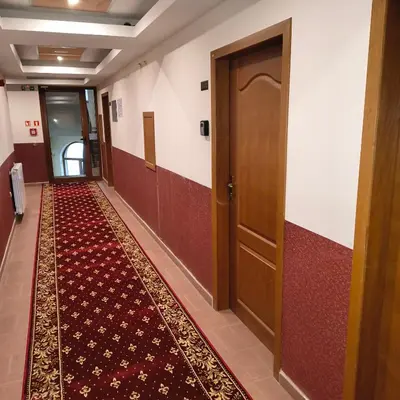a hallway with a door and a carpet at Ski view suite Emerald Bansko in Bansko