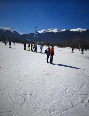 a group of people standing in the snow on a ski slope at Ski view suite Emerald Bansko in Bansko