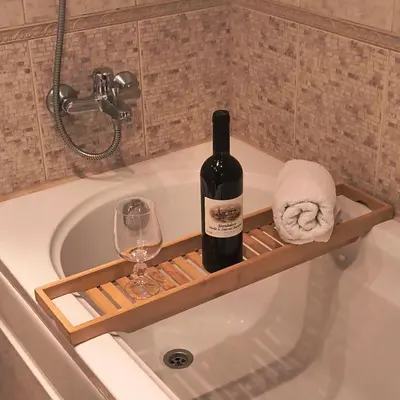 a bottle of wine and a glass in a bath tub at Ski view suite Emerald Bansko in Bansko