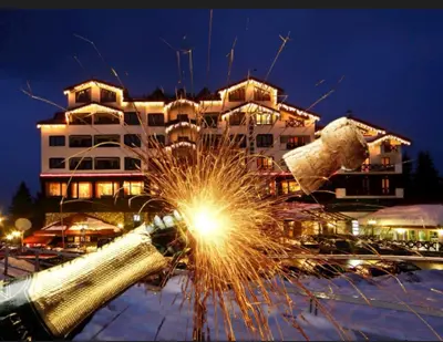 a sparkler in front of a building at night at Private Apartments in Hotel Snezhanka in Pamporovo