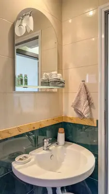 a bathroom with a sink and a mirror at Апартамент Панчо in Sofia
