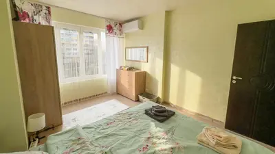 a small bedroom with a bed and a window at Апартамент Панчо in Sofia