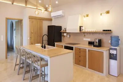 a kitchen with a counter and a island with bar stools at Villa Alma 1910 Starosel in Starosel