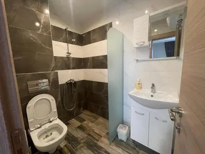 a small bathroom with a toilet and a sink at ZaraApartHotel in Sofia