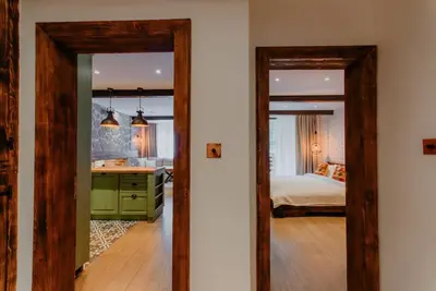 a room with a bedroom with a bed and a mirror at The Owl's Nest 2 in Velingrad