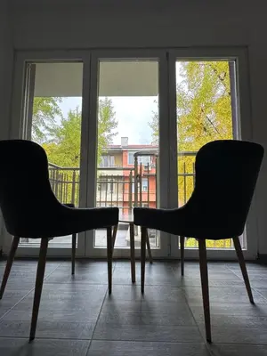 two chairs sitting in front of a window at Бутик хотел ресторант брасери и релакс зона Сажитариус in Kyustendil