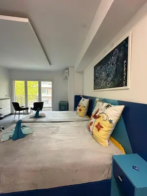 a bedroom with a large bed with pillows on it at Бутик хотел ресторант брасери и релакс зона Сажитариус in Kyustendil