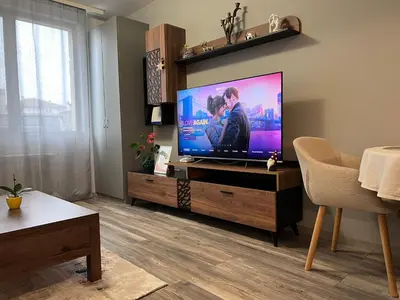 a living room with a large flat screen tv at Harmony apartment in Sofia