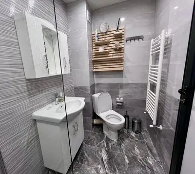 a bathroom with a white toilet and a sink at Harmony apartment in Sofia