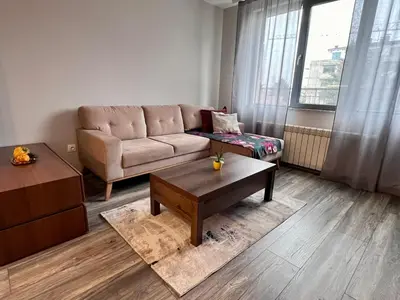 a living room with a couch and a coffee table at Harmony apartment in Sofia