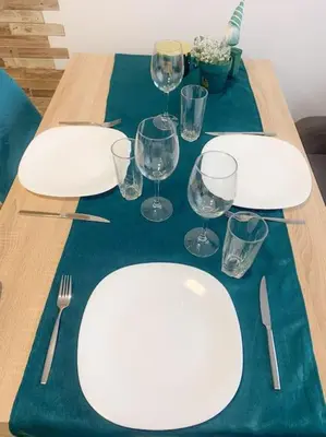 a table with white plates and wine glasses on it at Forest View Studio D25 in Borovets
