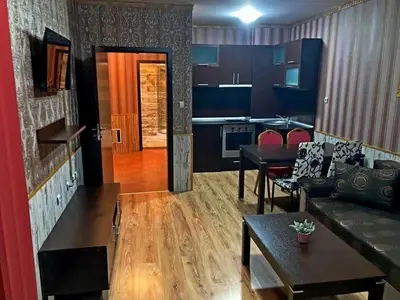 a living room with a couch and a table at Polaris Inn Apartments in Bansko