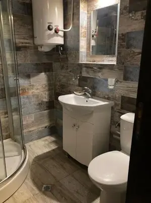 a bathroom with a toilet and a sink and a shower at Polaris Inn Apartments in Bansko