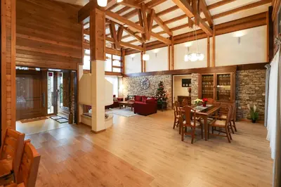 a large living room with a table and chairs at Villa Katerina Deluxe w Sauna - Pirin Golf and Country Club in Bansko