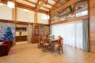 a living room with a table and a christmas tree at Villa Katerina Deluxe w Sauna - Pirin Golf and Country Club in Bansko
