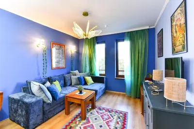 a living room with blue walls and a blue couch at Cedar Lodge III One BDRM Flat B2 in Bansko