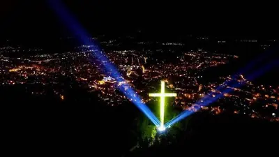 a cross on top of a city at night at Cozy & Delightful Apart & AUBG & Free Garage Parking in Blagoevgrad