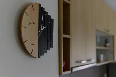 a clock hanging on a wall next to a mirror at Cozy & Delightful Apart & AUBG & Free Garage Parking in Blagoevgrad
