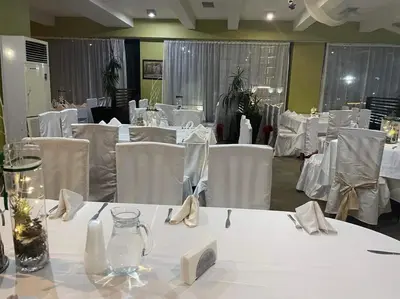a dining room with white tables and white chairs at Apartments Hotel Snejanka Pamporovo in Pamporovo