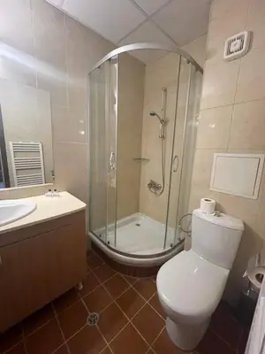 a bathroom with a shower and a toilet and a sink at Apartments Hotel Snejanka Pamporovo in Pamporovo