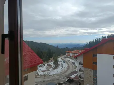 a view from a window of a mountain road at Ski holiday in Lucky Pamporovo in Pamporovo
