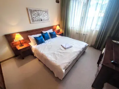 a bedroom with a large bed with blue pillows at Private 1bedroom apt in SPA Resort - SPA included in Bansko