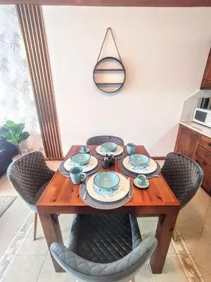 a dining room table with chairs and a wooden table with plates at Private 1bedroom apt in SPA Resort - SPA included in Bansko