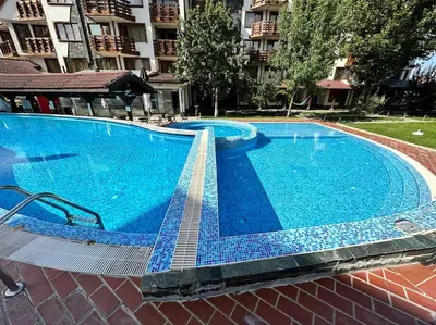 a large swimming pool with blue tile around it at Belvedere Holiday Club nice place in Bansko
