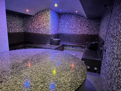 a room with a table in a room with purple lights at Belvedere Holiday Club nice place in Bansko
