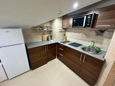 a small kitchen with a white refrigerator and a sink at Belvedere Holiday Club nice place in Bansko