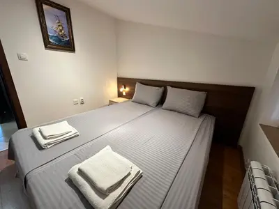 a bedroom with a large bed with towels on it at Belvedere Holiday Club nice place in Bansko