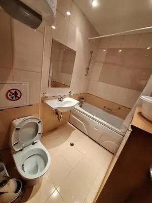 a small bathroom with a toilet and a sink at Top location ski-in ski-out and Swimming Pool in Bansko