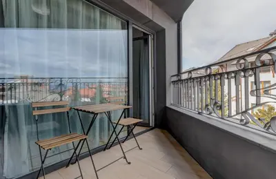 a balcony with two chairs and a table at Amuse Bouche by Skabrin in Bansko